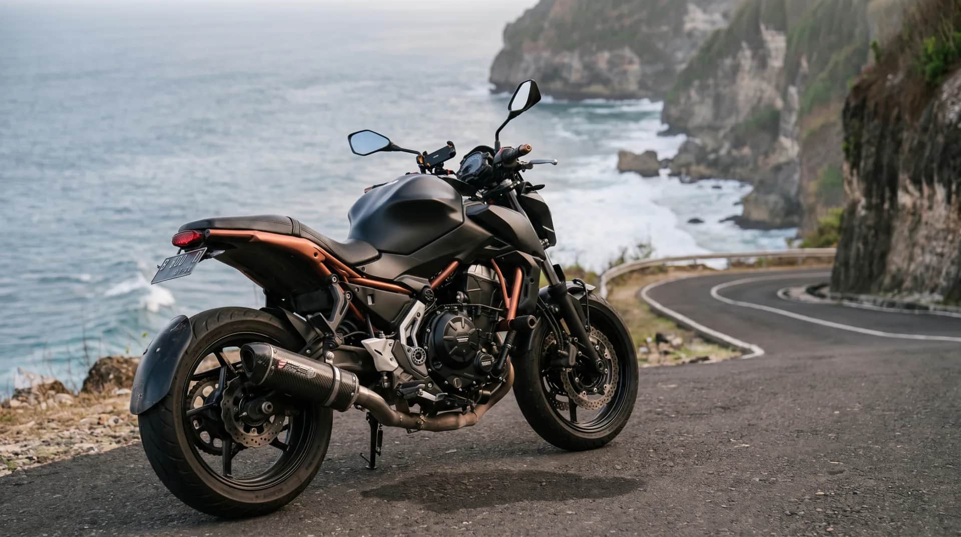 Kawasaki Z650 on a clifftop coastal road above the ocean in Bali