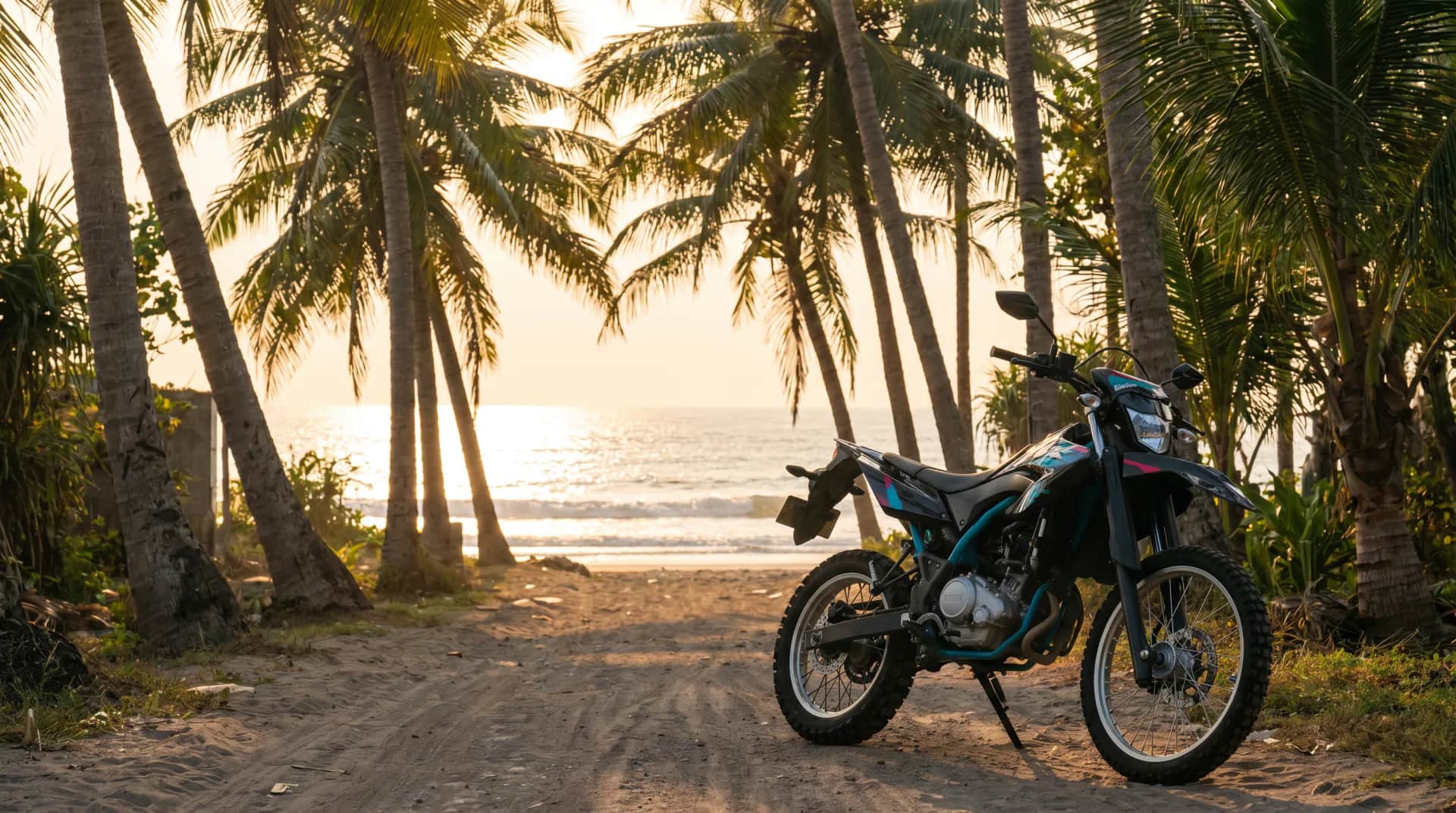 Yamaha WR155 enduro under coconut palms on a Bali beach at sunset