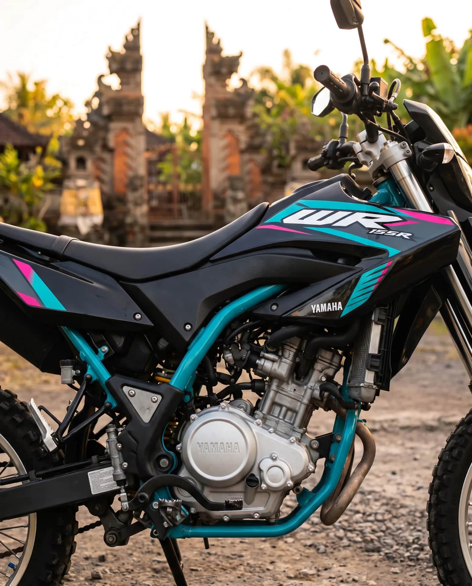 Yamaha WR155 fuel tank and engine detail with custom teal-and-pink WR graphics