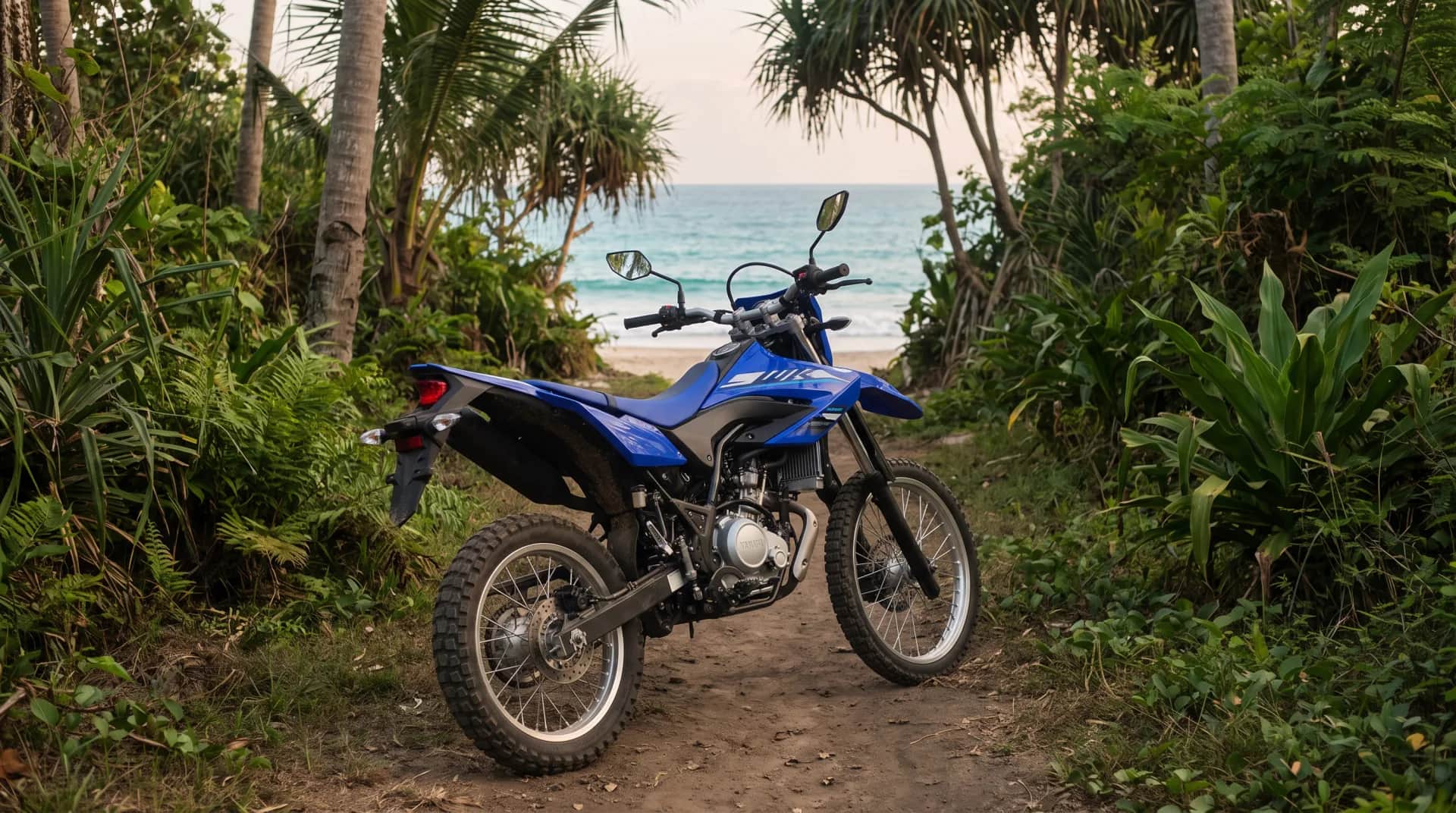 Blue Yamaha WR155 dual-sport on a concrete fishing pier at dawn in Bali with traditional jukung boats
